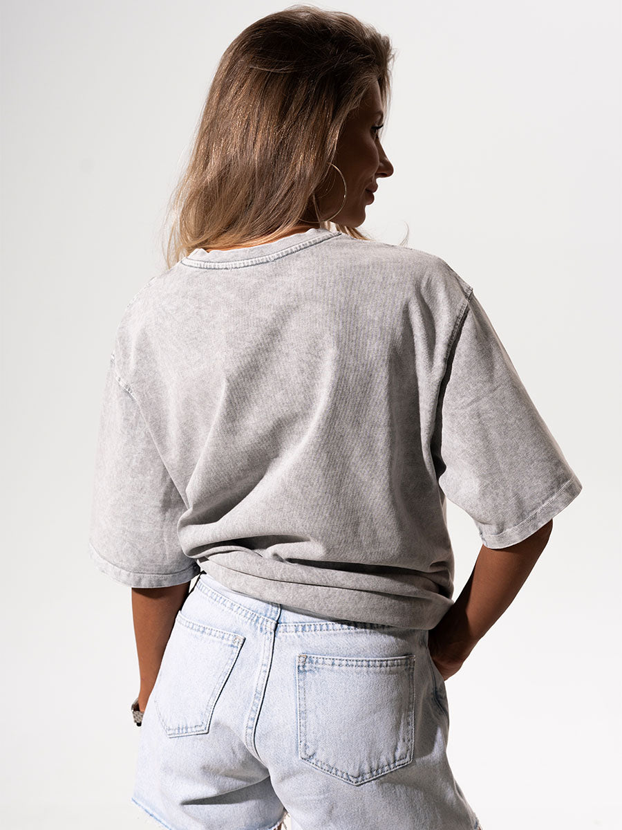 The t-shirt is in light gray color with the print It's OK to fall
