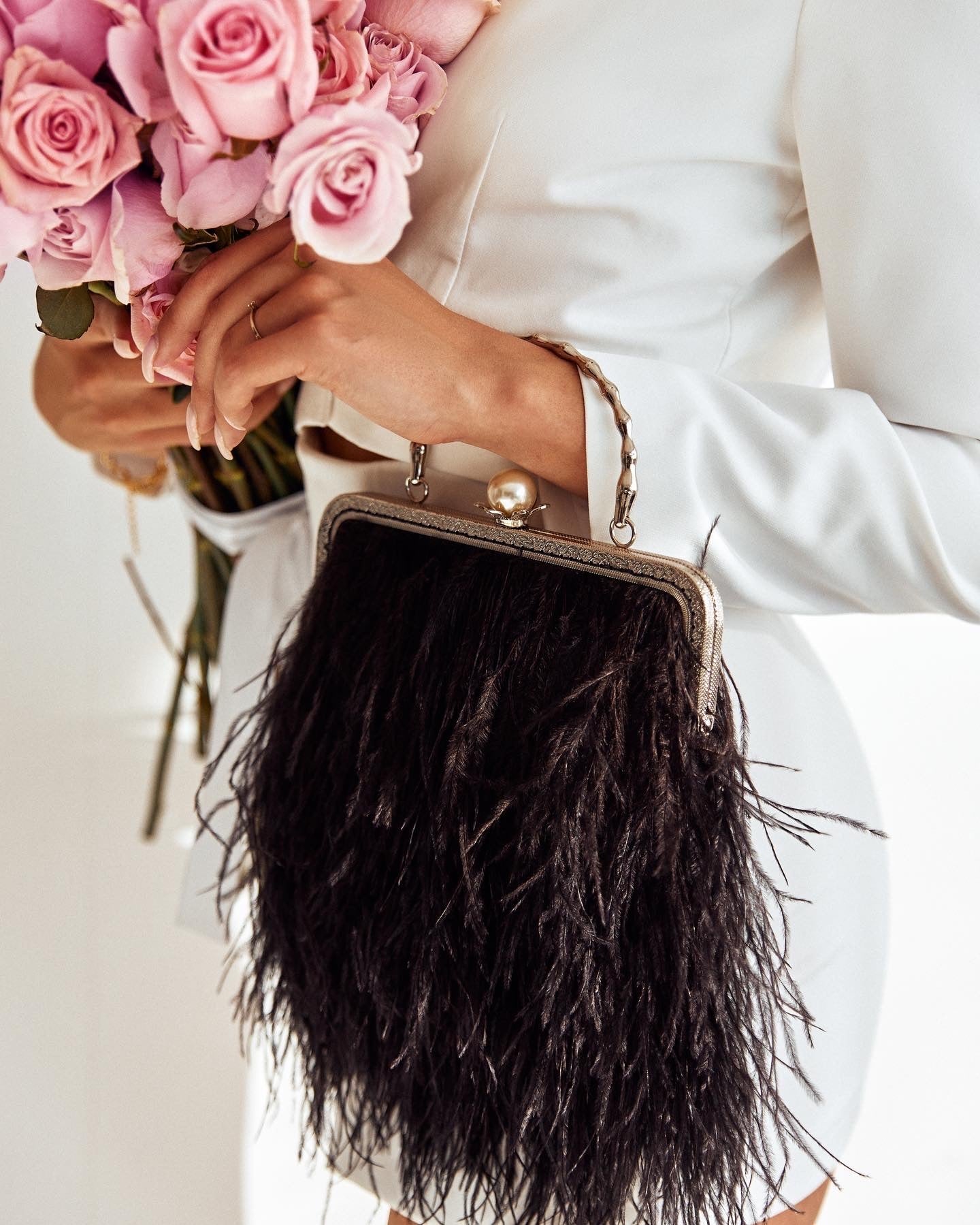 Black bag with a pearl decorated handle