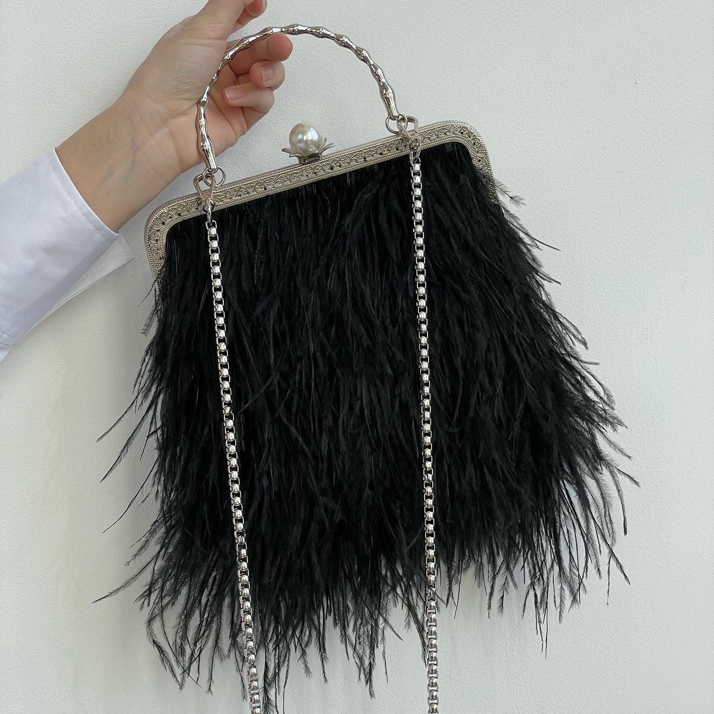 Black bag with a pearl decorated handle