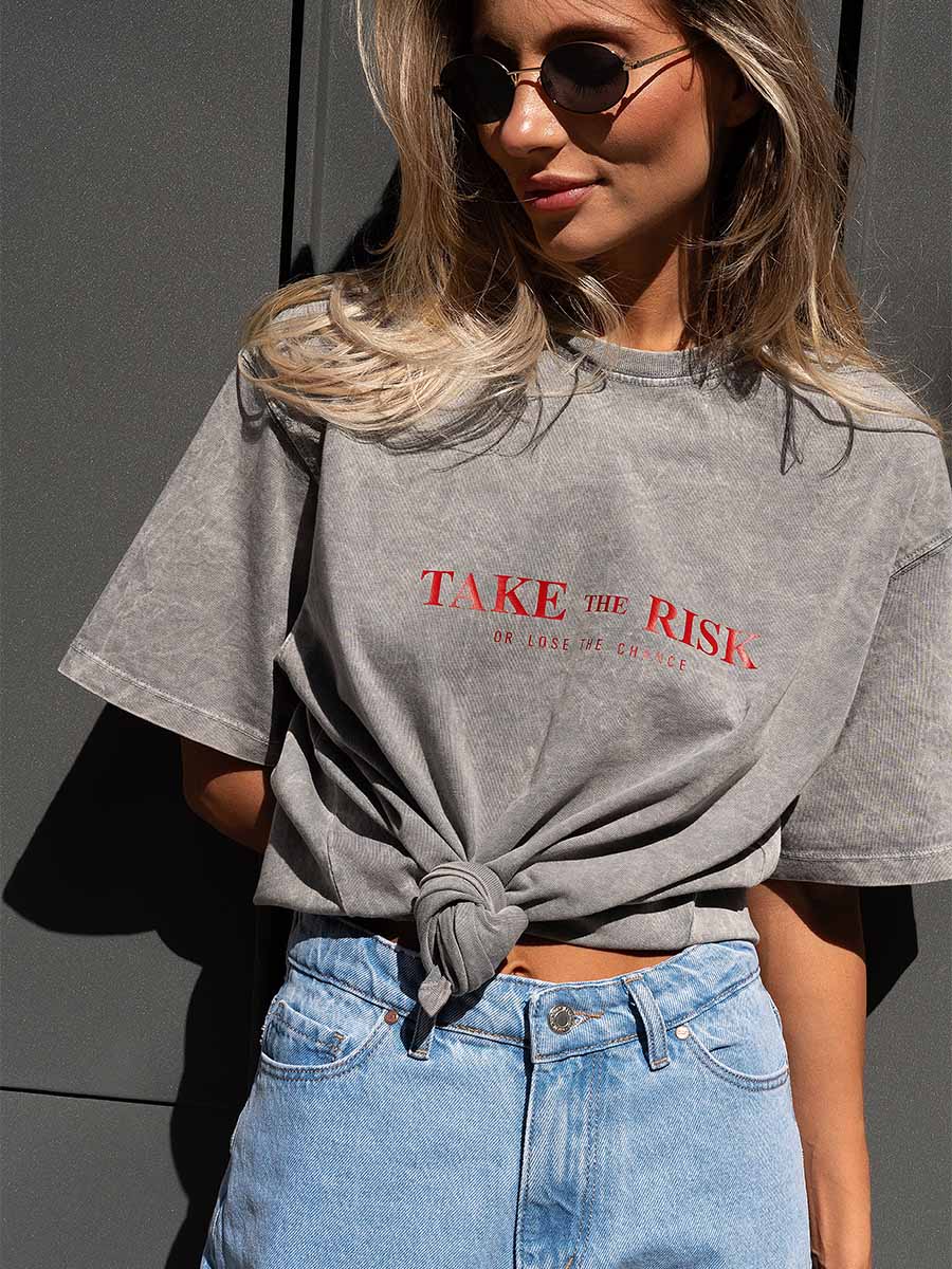T-shirt cooked in light gray color with Take the risk print