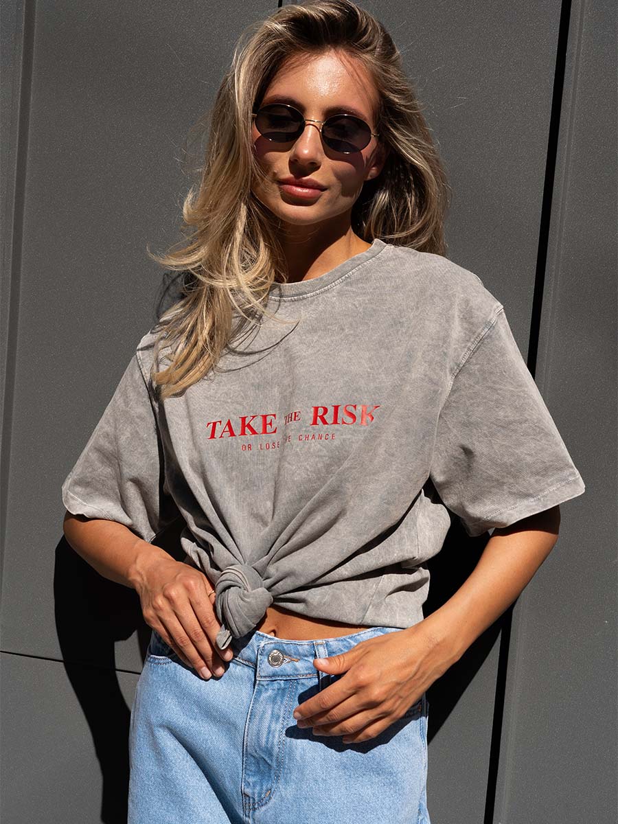 T-shirt cooked in light gray color with Take the risk print
