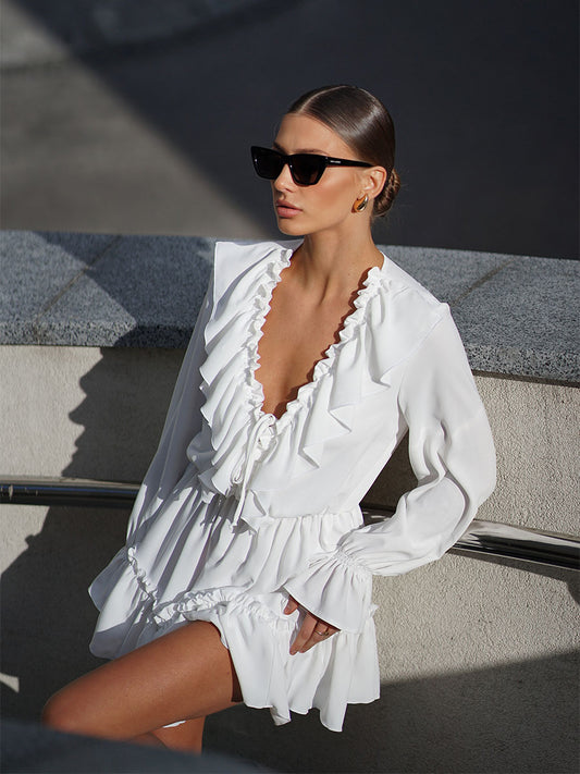 White mini dress with a frill on the bottom