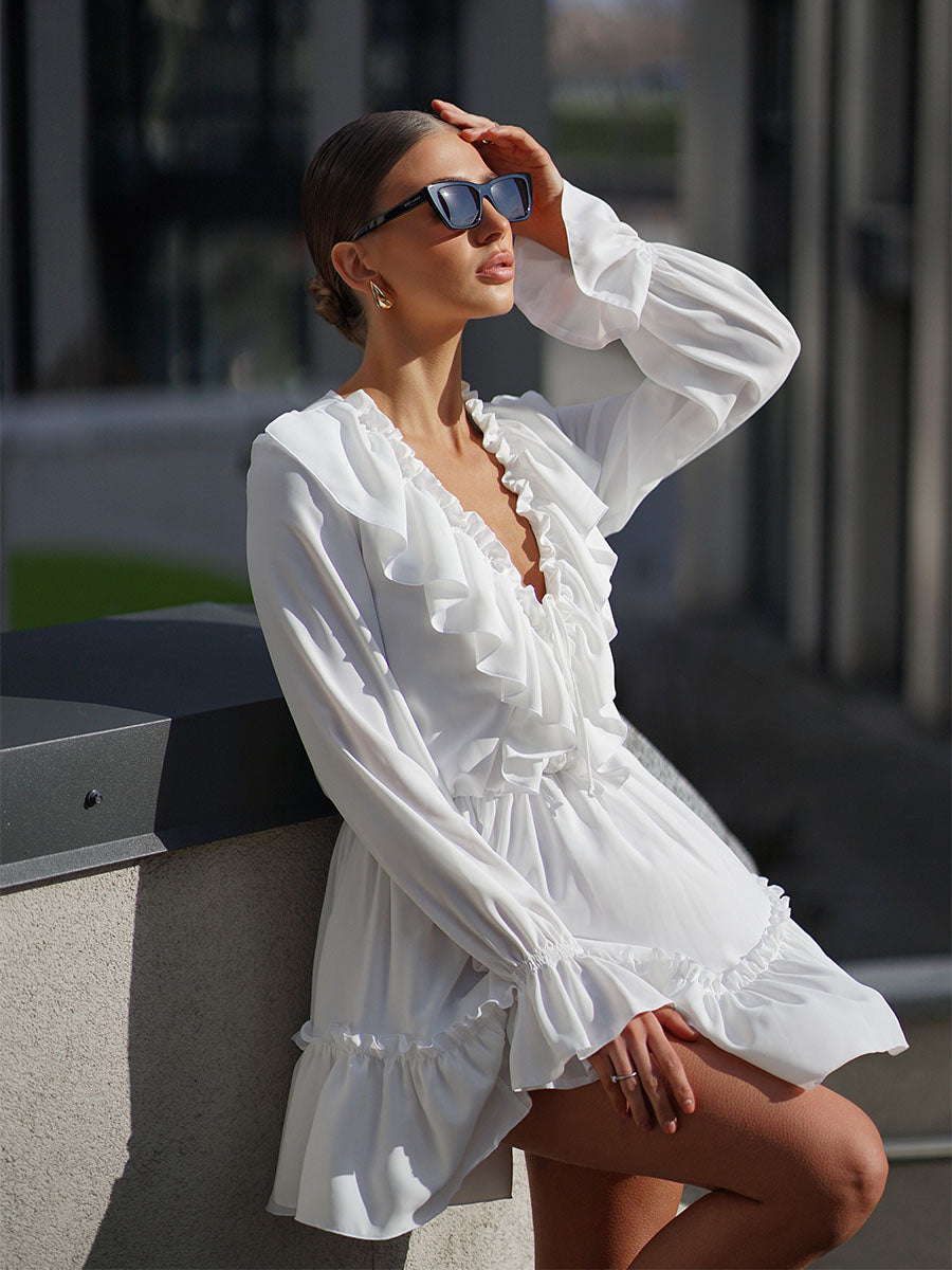White mini dress with a frill on the bottom