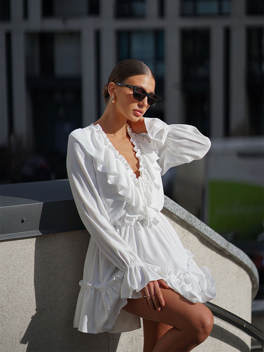 White mini dress with a frill on the bottom