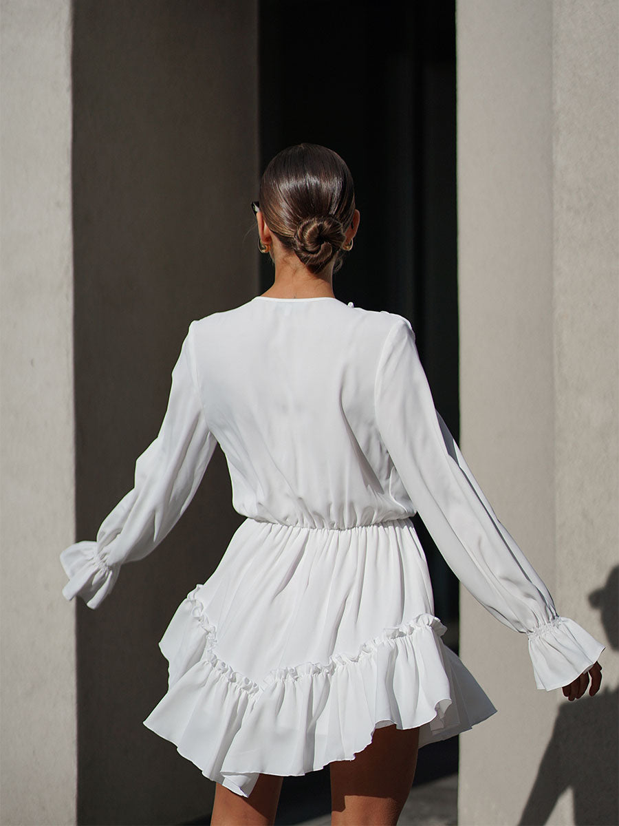 White mini dress with a frill on the bottom