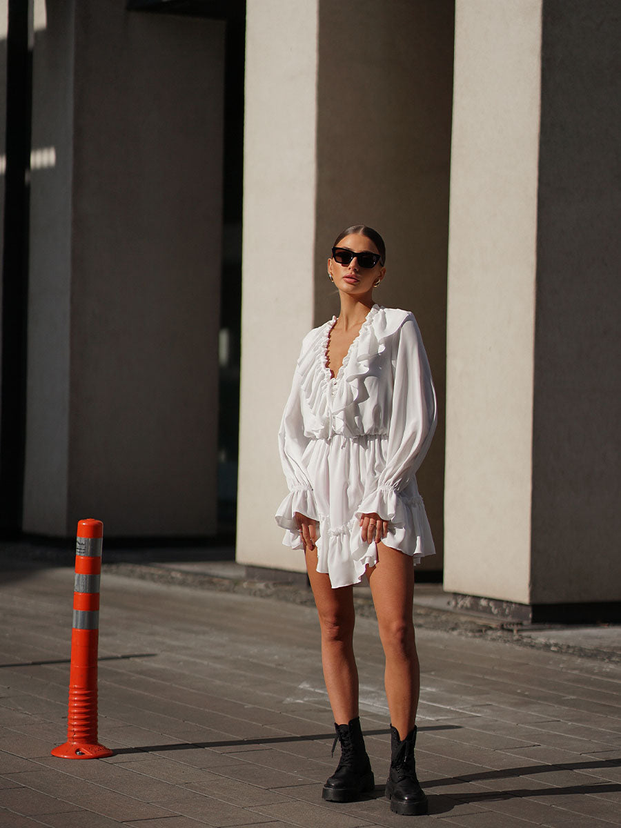 White mini dress with a frill on the bottom