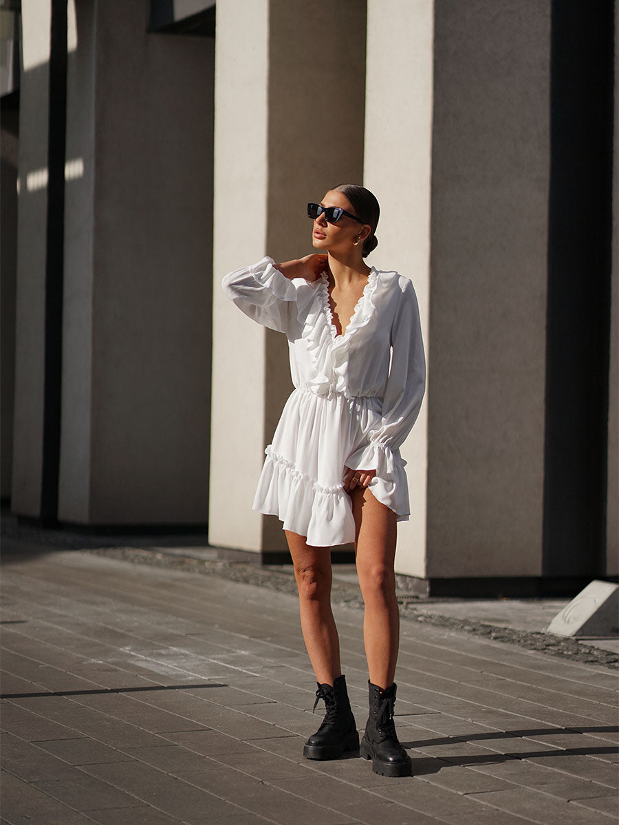 White mini dress with a frill on the bottom