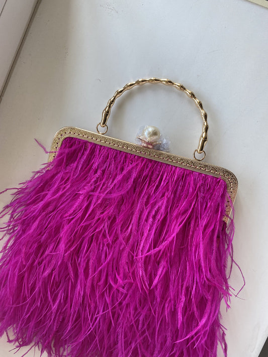 Fucsia bag with a pearl decorated handle