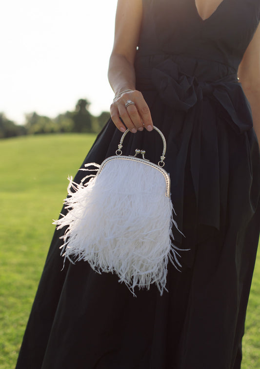 White bag with a flower decorated handle