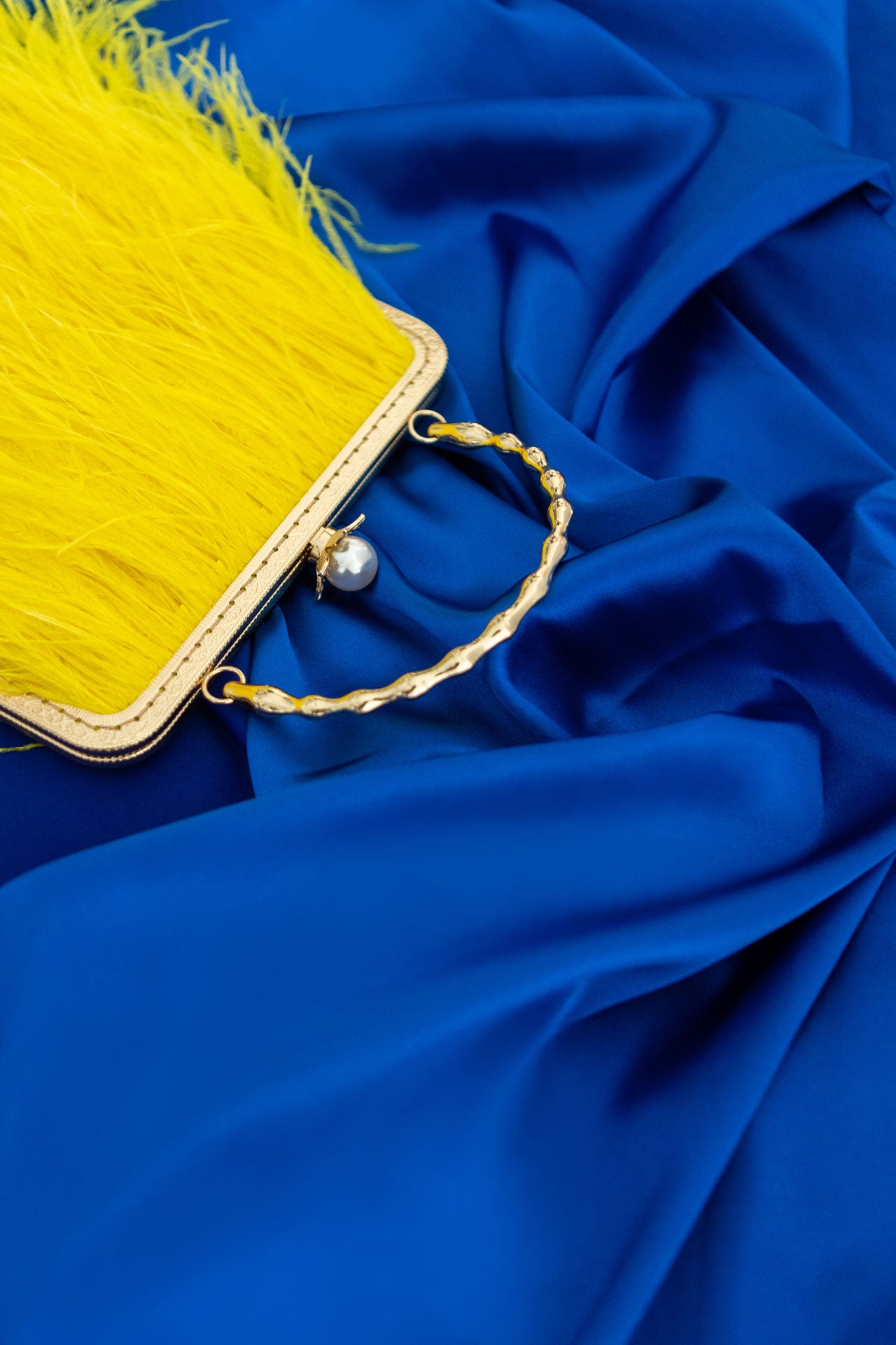 Yellow bag with a pearl decorated handle