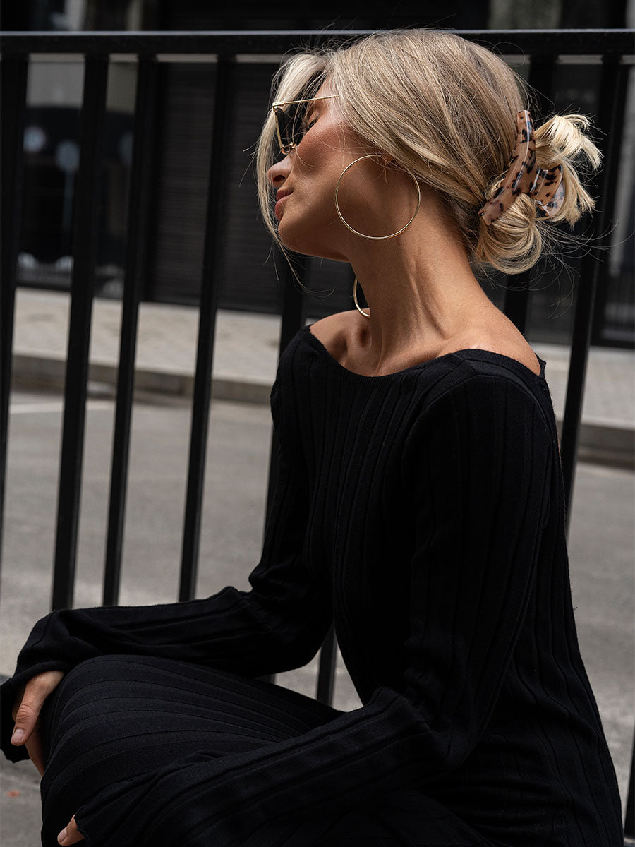 Black knitted midi dress with a cutout on the back